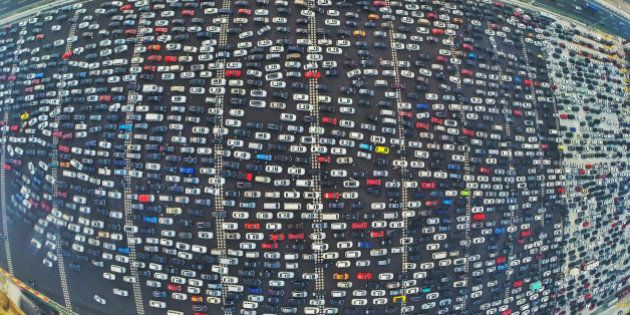 BEIJING, CHINA - OCTOBER 06: (CHINA OUT) (EDITORS NOTE: Image captured with a fisheye lens) Aerial view of cars queuing up to pass a checkpoint set recently in the direction of Beijing on the Beijing-Hong Kong-Macau Expressway at the end of National Day Holiday on October 6, 2015 in Beijing, China. A travel peak appeared at the end of 7-day China's National Day Holiday. (Photo by ChinaFotoPress/ChinaFotoPress via Getty Images)
