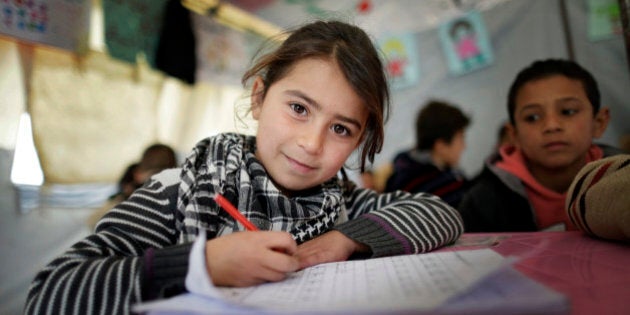 ZAHLE, LEBANON - DECEMBER 09: Girl at a provisional elementary school of an informal tented settlement of Syrian refugees on December 09, 2014 in Zahle, Lebanon. The ongoing civil war in Syria continues to force masses of Syrians into neighboring Lebanon. (Photo by Thomas Koehler/Photothek via Getty Images)