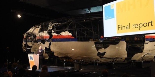 Dutch Safety Board Chairman Tjibbe Joustra speaks in front of the wrecked cockpit of the Malaysia Airlines flight MH17 exhibited during a presentation of the final report on the cause of the its crash at the Gilze Rijen airbase October 13, 2015. Air crash investigators have concluded that Malaysia Airlines flight MH17 was shot down by a missile fired from rebel-held eastern Ukraine, sources close to the inquiry said today, triggering a swift Russian denial. The findings are likely to exacerbate the tensions between Russia and the West, as ties have strained over the Ukraine conflict and Moscow's entry into the Syrian war. AFP PHOTO / EMMANUEL DUNAND (Photo credit should read EMMANUEL DUNAND/AFP/Getty Images)