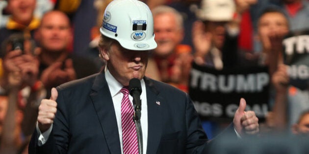 CHARLESTON, WV - MAY 05: Republican Presidential candidate Donald Trump models a hard hat in support of the miners during his rally at the Charleston Civic Center on May 5, 2016 in Charleston, West Virginia. Trump became the Republican presumptive nominee following his landslide win in indiana on Tuesday.(Photo by Mark Lyons/Getty Images)