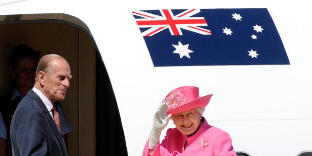 FILE - In this Oct. 26, 2011 file photo, Britain's Queen Elizabeth II, right, and her husband Prince Philip board a plane flying to Perth from Melbourne airport, Australia, on their way to attend the Commonwealth heads of government meeting in Perth. Australia's prime minister on Monday, Jan. 26, 2015 dismissed criticism of his decision to the Duke of Edinburgh an Australian knight, saying Philip has a long history of service Down Under. Prime Minister Tony Abbott's announcement that the duke would be awarded Australia's highest honor came on Australia's national holiday, prompting some to question the wisdom of knighting a British royal on a day meant to commemorate Australians. (AP Photo/Andrew Brownbill, File)