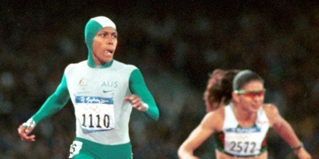 Australia's Cathy Freeman crosses the finish line to win the gold medal in the 400-meter race Monday, Sept. 25, 2000 at Olympic Stadium in Sydney. Mexico's Ana Guevara is at right. (AP Photo/Doug Mills)