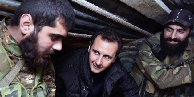 FILE -- In this Wednesday, Dec. 31, 2014, file photo released by the Syrian official news agency SANA, Syrian President Bashar Assad, center, speaks with Syrian troops during his visit to the front line in the eastern Damascus district of Jobar, Syria. A Russian initiative to host peace talks this month between the Syrian government and its opponents appears to be unraveling, as prominent Syrian opposition figures shun the planned negotiations over concerns that the framework is flawed and holds little chance of success. (AP Photo/SANA, File)