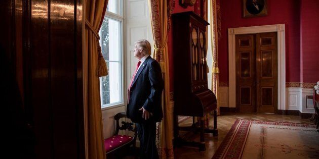 President Donald Trump looks out of the Red Room window onto the South Portico of the White House grounds on Jan. 20, 2017, before departing the White House for his inauguration.