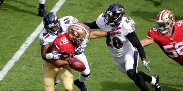 San Francisco 49ers' Jarryd Hayne (38) fumbles a punt-return while tackled by Baltimore Ravens' Anthony Levine (41) and Brynden Trawick (28) during the first half of an NFL football game in Santa Clara, Calif., Sunday, Oct. 18, 2015. The 49ers recovered the fumble. (AP Photo/Marcio Jose Sanchez)
