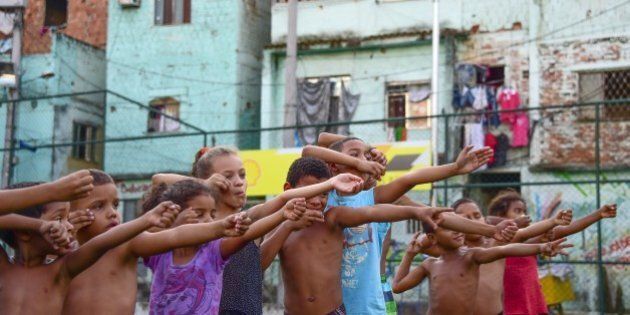 Children from the Sao Carlos Shantytown learn archery in Rio de Janeiro, Brazil on September 16, 2015. AFP PHOTO / CHRISTOPHE SIMON (Photo credit should read CHRISTOPHE SIMON/AFP/Getty Images)