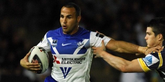 TOWNSVILLE, AUSTRALIA - AUGUST 31: Hazem Elmasri of the Bulldogs looks to get past Ben Farrar of the Cowboys during the round 25 NRL match between the North Queensland Cowboys and the Bulldogs at Dairy Farmers Stadium August 31, 2007 in Townsville, Australia. (Photo by Ian Hitchcock/Getty Images)