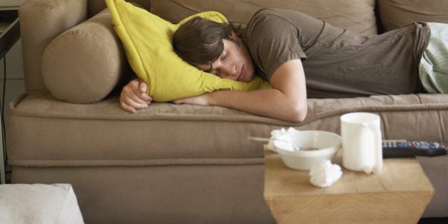 Young adult man sleeping on sofa