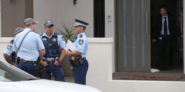 Police attend a property in the suburb of Merrylands in Sydney, Wednesday, Oct. 7, 2015. Police arrested four people during a series of raids Wednesday in connection with the slaying of a civilian police worker, which officials have said they believe was linked to terrorism. (AP Photo/Rick Rycroft)