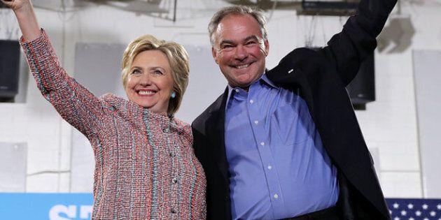 ANNANDALE, VA - JULY 14: Democratic presidential candidate Hillary Clinton (L) and U.S. Sen. Tim Kaine (D-VA) (R) acknowledge the crowd during a campaign event at Ernst Community Cultural Center at Northern Virginia Community College July 14, 2016 in Annandale, Virginia. Hillary Clinton continued to campaign for the general election in November. (Photo by Alex Wong/Getty Images)