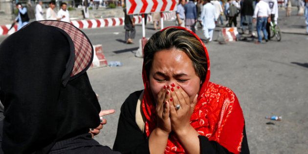 An Afghan woman weeps at the site of a suicide attack in Kabul on Saturday. The attack was claimed by the Islamic State militant group.
