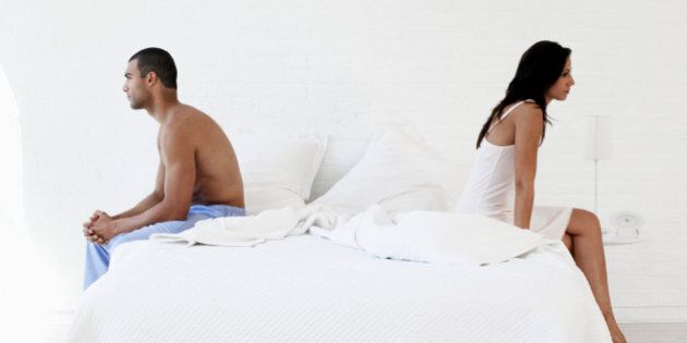 Couple Sitting on Bed