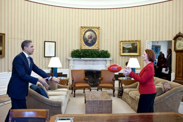 U.S. President Barack Obama practices passing a football with Prime Minister Julia Gillard in the Oval Office in 2011