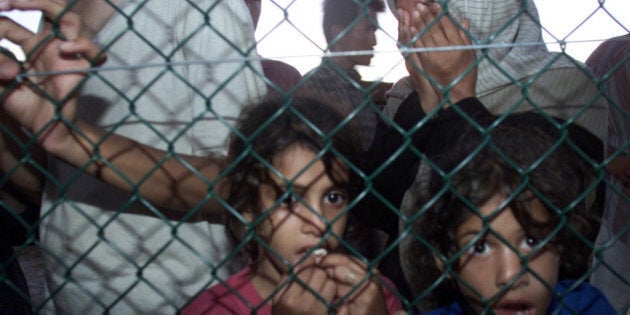 (AUSTRALIA & NEW ZEALAND OUT) Asylum seekers both from the Tampa and Aceng arrive at Nauru off the Australian Navy troop carrier HMAS Manoora today, 19 September 2001. THE AGE NEWS Picture by ANGELA WYLIE (Photo by Fairfax Media/Fairfax Media via Getty Images)