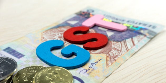 GST or Goods and Services Tax alphabet letters with Malaysian currency. Concept of Government Service Tax. Slightly defocused and close-up shot.