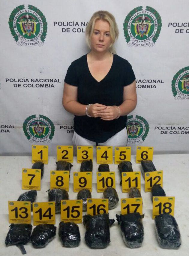 A shell-shocked looking Cassie Sainsbury in handcuffs after her arrest at the international airport in Bogota, Colombia on April 12.