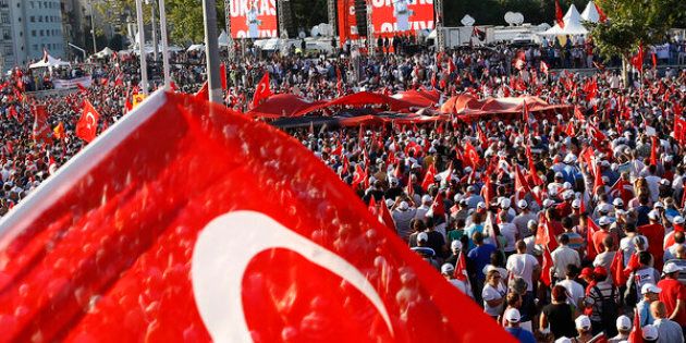 A man waves Turkey's national flag as he with supporters of various political parties gathers in Istanbul's Taksim Square during the Republic and Democracy Rally organised by main opposition Republican People's Party (CHP), Turkey, July 24, 2016. REUTERS/Osman Orsal