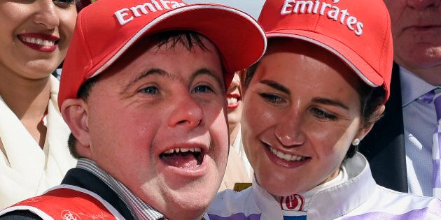 Prince of Penzance jockey Michelle Payne, right, celebrates with strapper Stevie Payne, left, after winning the Melbourne Cup at Flemington Racecourse in Melbourne, Australia, Tuesday, Nov. 3, 2015. Michelle Payne became the first female jockey to win the Melbourne Cup on Tuesday when she rode the 100-1 outsider Prince of Penzance to victory in Australia's richest horse race. (AP Photo/Andy Brownbill)
