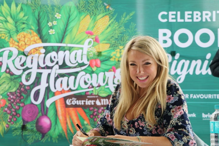 Nutritionist Lola Berry signing her cookbooks after a cooking demonstration.