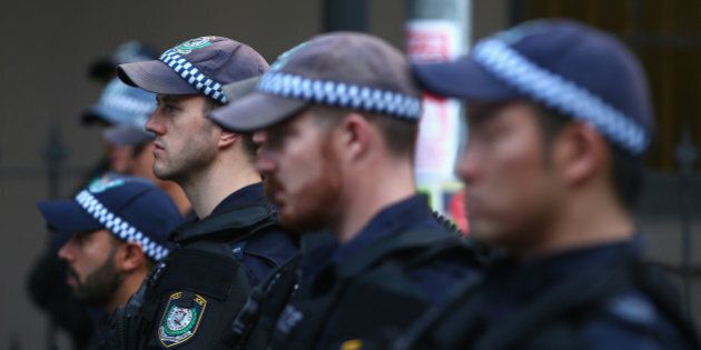 SYDNEY, AUSTRALIA - OCTOBER 09: Police watch on as they separate protestors in Marden street outside Parramatta Mosque on October 9, 2015 in Sydney, Australia. Protesters gathered at Parramatta Mosque after calls for its destruction by the group 'Party for Freedom'. It is alleged Farhad Jabar attended the mosque sometime before he murdered Police worker Curtis Cheng earlier this week. (Photo by Mark Kolbe/Getty Images)