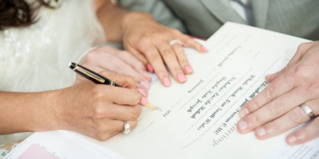 Bride & Groom signing marriage certificate