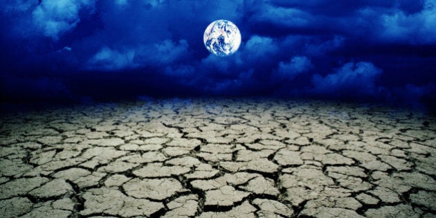 Cracked mud, Earth in air in background (digital composite)