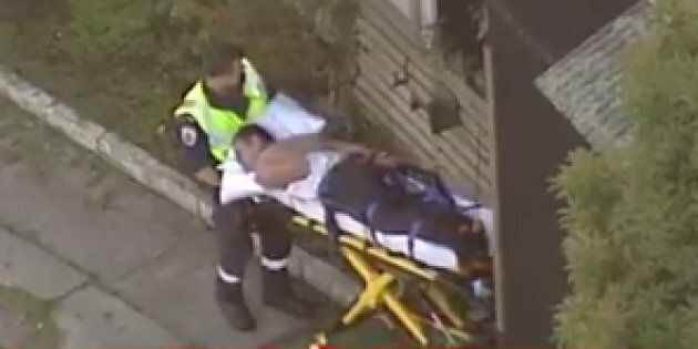 A man is stretchered from the scene of a siege in Melbourne.