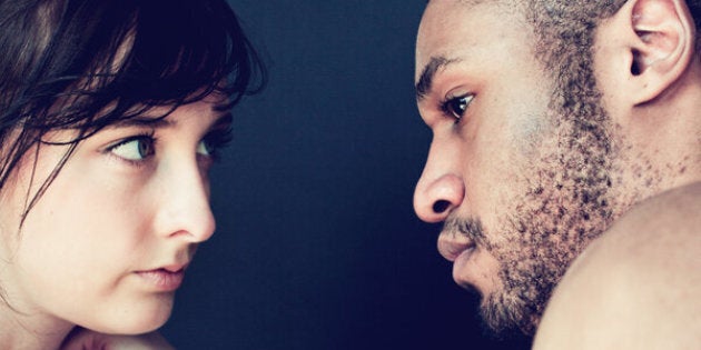 Portrait of a young couple sitting face to face in a thoughtful mood.