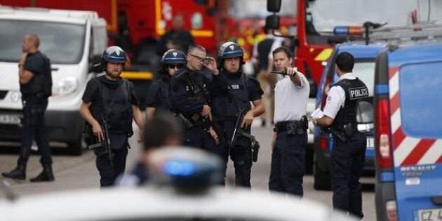 French police officers and fire engine arrive at the scene of a hostage-taking at a church in Saint-Etienne-du-Rouvray, northern France, on July 26, 2016 that left the priest dead.A priest was killed on July 26 when men armed with knives seized hostages at a church near the northern French city of Rouen, a police source said. Police said they killed two hostage-takers in the attack in the Normandy town of Saint-Etienne-du-Rouvray, 125 kilometres (77 miles) north of Paris. / AFP / CHARLY TRIBALLEAU (Photo credit should read CHARLY TRIBALLEAU/AFP/Getty Images)