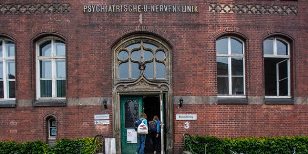 A police car is parked in front of the university clinic in Steglitz, a southwestern district of Berlin.