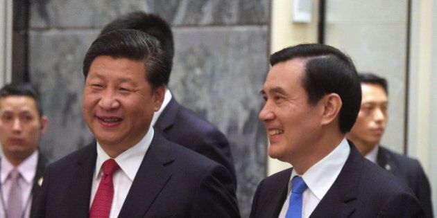 Chinese President Xi Jinping, left, and Taiwanese President Ma Ying-jeou, right, smile as they enter the room at the Shangri-la Hotel where they met on Saturday, Nov. 7, 2015, in Singapore. The two leaders shook hands at the start of a historic meeting marking the first top level contact between the formerly bitter Cold War foes since they split amid civil war 66 years ago. (AP Photo/Joseph Nair, pool)