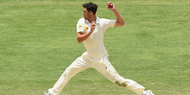 BRISBANE, AUSTRALIA - NOVEMBER 09: Mitchell Starc of Australia fields off his own bowling during day five of the First Test match between Australia and New Zealand at The Gabba on November 9, 2015 in Brisbane, Australia. (Photo by Matt Roberts - CA/Cricket Australia/Getty Images)