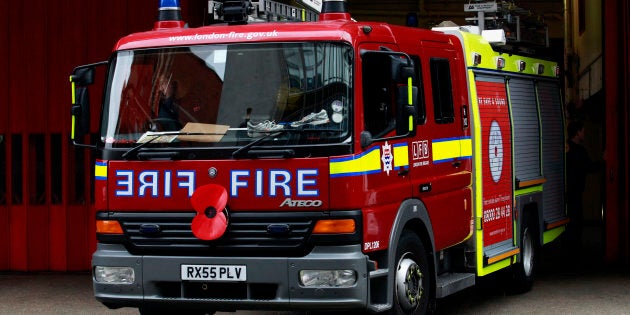 A fire engine reverses into a fire station in London October 22, 2010. London's fire brigade will only be responding to serious incidents on Saturday as firefighters prepare to hold an eight-hour strike, officials said. REUTERS/Luke MacGregor (BRITAIN - Tags: EMPLOYMENT BUSINESS)