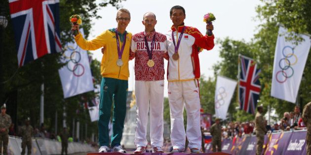 LONDON, ENGLAND - AUGUST 11: (L-R) Silver medalist Jared Tallent of Australia, gold medalist Sergey Kirdyapkin of Russia and bronze medalist Tianfeng Si of China pose during the medal ceremony for the Men's 50km Walk on Day 15 of the London 2012 Olympic Games on The Mall on August 11, 2012 in London, England. (Photo by Streeter Lecka/Getty Images)
