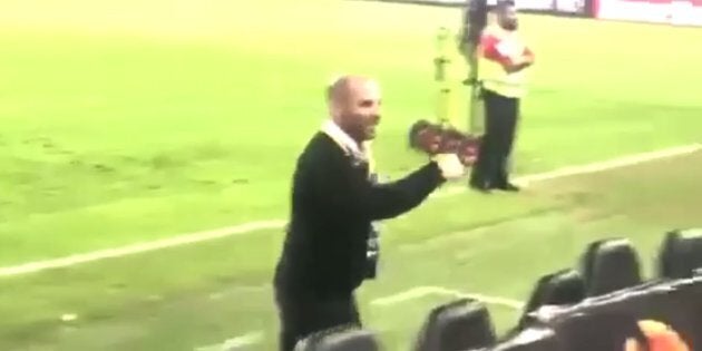 Footage shows George Calombaris shouting and gesturing to members of the crowd in the stadium.