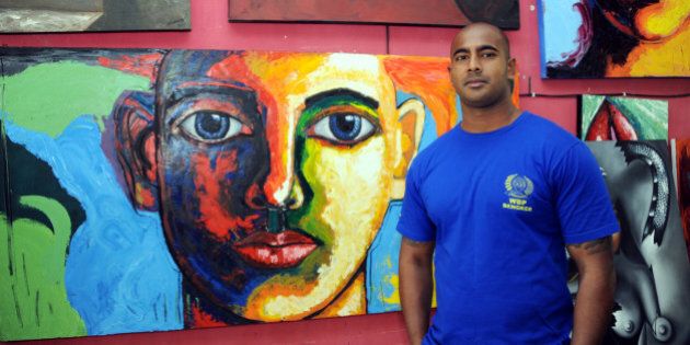 Australian drug smuggler Myuran Sukumaran, one of the so-called 'Bali Nine' gang, stands in front of his paintings at a prisoners studio in Kerobokan prison, Denpasar, on the Bali island on September 28, 2011. Sukumaran, who was arrested in 2005 for drug smuggling and sentenced to death, has lost his final appeal against the punishment. AFP PHOTO / SONNY TUMBELAKA (Photo credit should read SONNY TUMBELAKA/AFP/Getty Images)