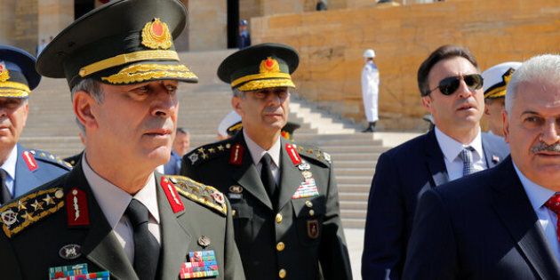 Turkey's Prime Minister Binali Yildirim (R), flanked by Chief of Staff General Hulusi Akar (L) and the country's top generals, leaves Anitkabir the mausoleum of modern Turkey founder Mustafa Kemal Ataturk in Ankara on Thursday.