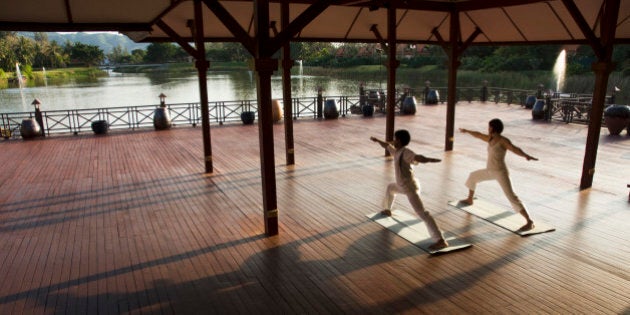 People performing yoga, Thailand.