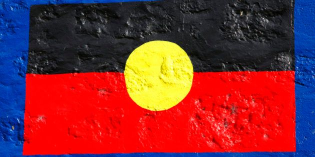 Aboriginal flag painted on stone wall. Official flag of indigenous people of Australia Aborigines also called Aboriginal Australians. South Australia.