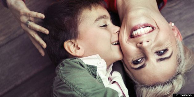 young boy kissing her mum
