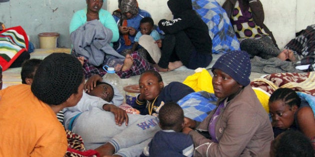 Illegal African migrants sit in a shelter following their arrival by boat at the Zawiyah port, a Libyan naval base some 45 kilometres west of the capital Tripoli, after they were rescued off the western city of Sabratha on May 24, 2016 as they were trying to reach Europe by boat. Workers on a Libyan oil tanker helped to rescue 135 people from boats in the Mediterranean, an AFP journalist said, hours after coastguards detained 550 would-be migrants headed for Europe. Libyan coastguards earlier today that they had detained 550 people trying to reach Europe illegally by boat / AFP / MAHMUD TURKIA (Photo credit should read MAHMUD TURKIA/AFP/Getty Images)