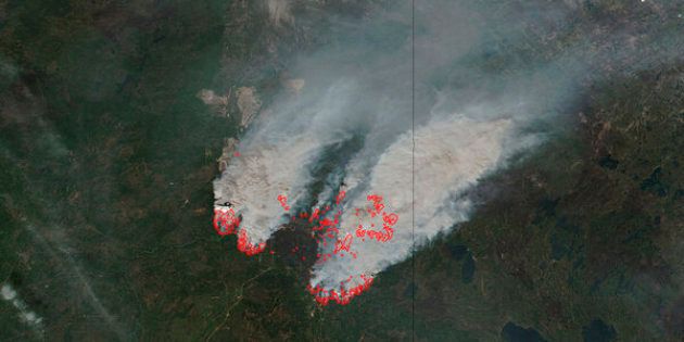 NASA's satellite image shows columns of smoke rising up from the myriad of wildfires, with NASA outlining actively burning areas in red over the Fort McMurray, Alberta, Canada on May 16, 2016
