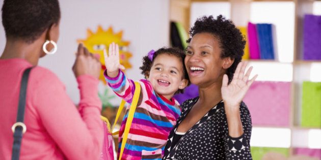 Mother and child waving to teacher