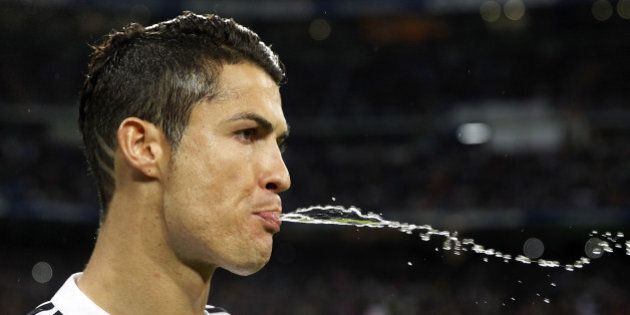 MADRID, SPAIN - NOVEMBER 08: Cristiano Ronaldo of Real Madrid spits out water before the La Liga match between Real Madrid and Rayo Vallecano at Estadio Santiago Bernabeu on November 8, 2014 in Madrid, Spain. (Photo by Angel Martinez/Real Madrid via Getty Images)