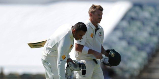 Australia's David Warner (R) and teammate Usman Khawaja (L) take a drinks break on the first day of the second Test cricket match between Australia and New Zealand in Perth on November 13, 2015. AFP PHOTO / Greg WOOD--IMAGE RESTRICTED TO EDITORIAL USE NO COMMERCIAL USE-- (Photo credit should read GREG WOOD/AFP/Getty Images)