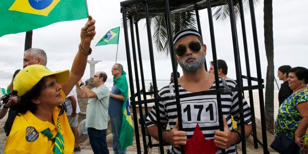 Protesters take part in a demonstration to demand the impeachment of suspended President Dilma Rousseff on Copacabana beach