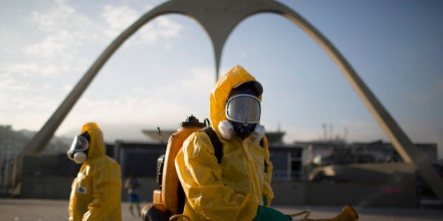 A health worker stands in the Sambadrome as he sprays insecticide to combat the Aedes aegypti mosquitoes that transmits the Zika virus in Rio de Janeiro, Brazil, Tuesday, Jan. 26, 2016. Inspectors begin to spray insecticide around Sambadrome, the outdoor grounds where thousands of dancers and musicians will parade during the city's Feb. 5-10 Carnival celebrations. Brazil's health minister says the country will mobilize some 220,000 troops to battle the mosquito blamed for spreading a virus linked to birth defects. (AP Photo/Leo Correa)