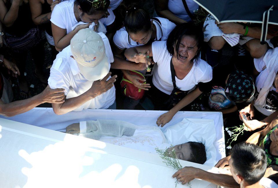 Jennilyn Olayres cries at the coffin of her partner Michael Siaron who was killed by suspected vigilantes acting on Duterte's call to kill drug dealers.