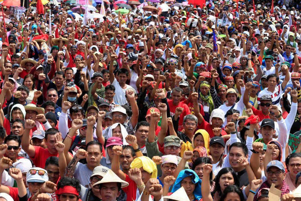 Philippine President Rodrigo Duterte supporters clench their fists during a rally.