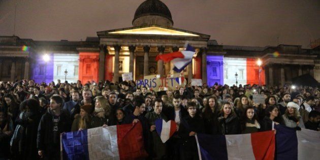 LONDON, ENGLAND - NOVEMBER 14: The National Portrait Gallery lit up in the colours of the French national flag during a vigil to pay respect to the victims of France terror attacks, at Trafalgar Square, London on November 14, 2015. At least 129 people were killed and 352 others injured -- 99 of them in critical condition -- after the terror attacks in Paris on 13 November. (Photo by Tayfun Salci/Anadolu Agency/Getty Images)